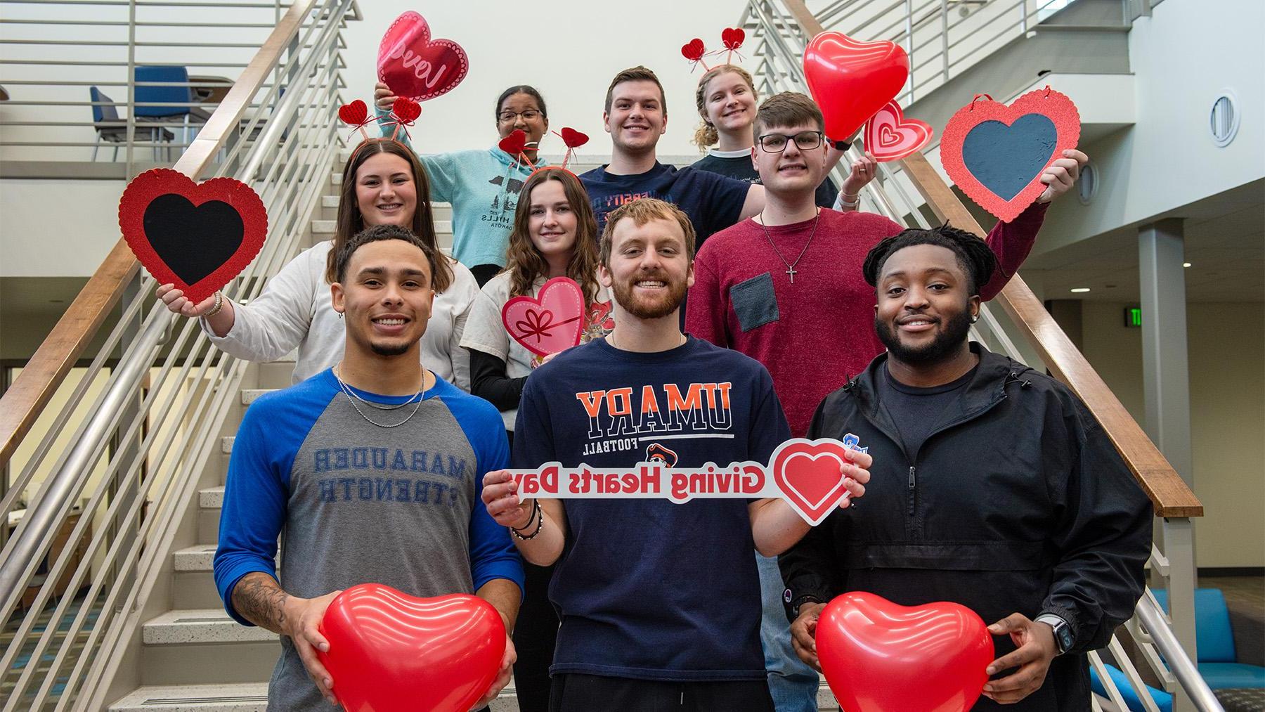 Students with hearts on the staircase